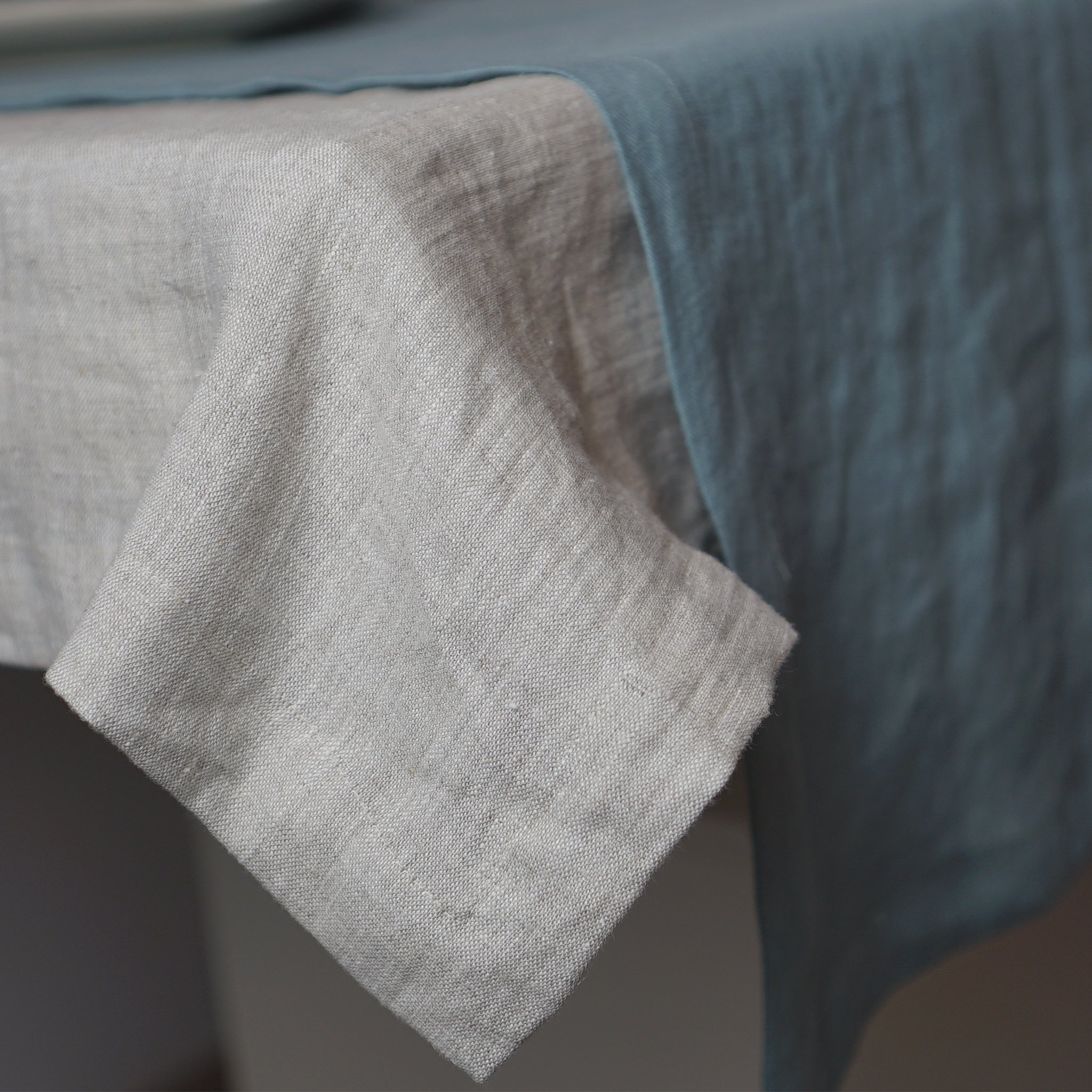 Pale Pink linen tablecloth draped elegantly over a dining table, showcasing its soft texture and luxurious appearance.