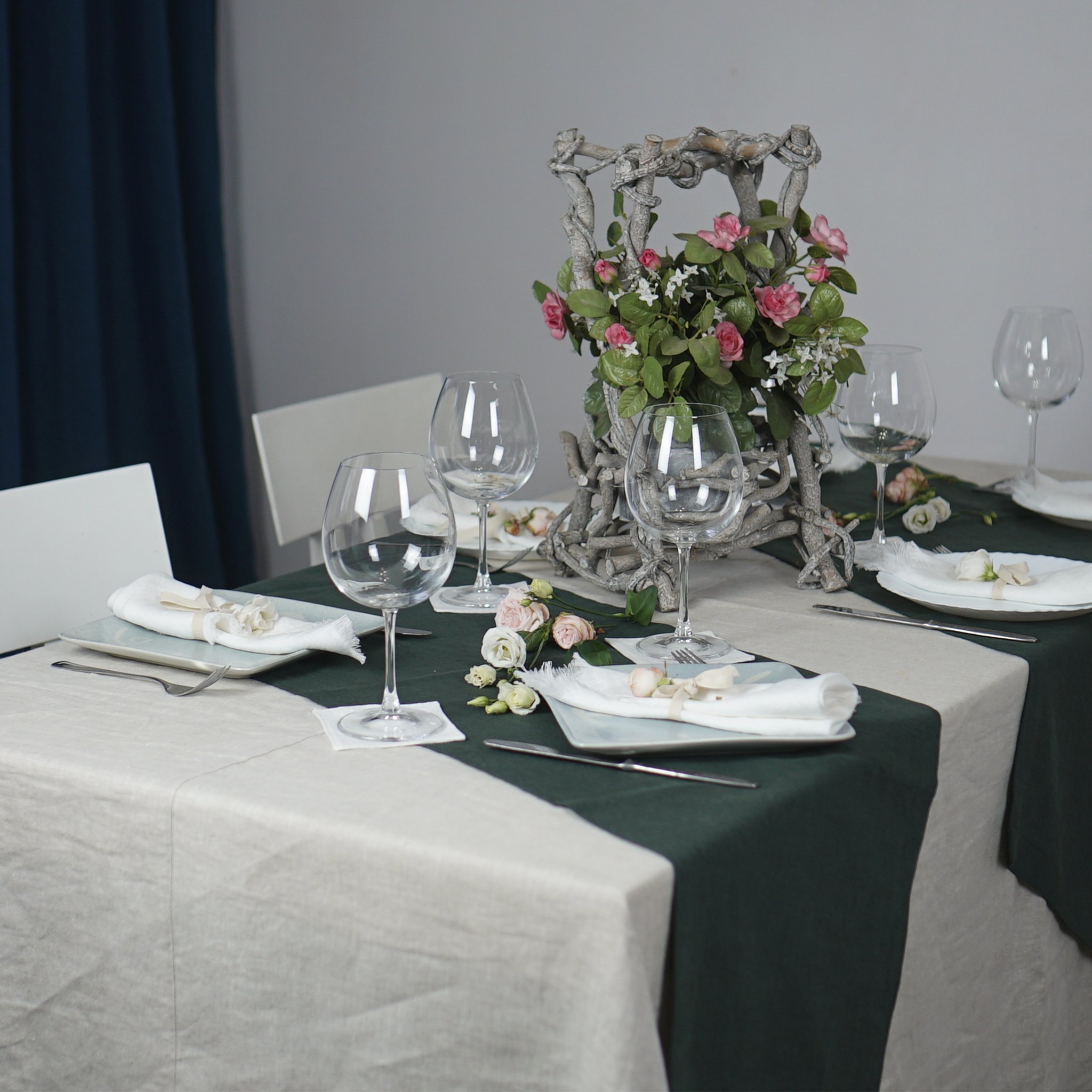 Pale Pink linen tablecloth draped elegantly over a dining table, showcasing its soft texture and luxurious appearance.