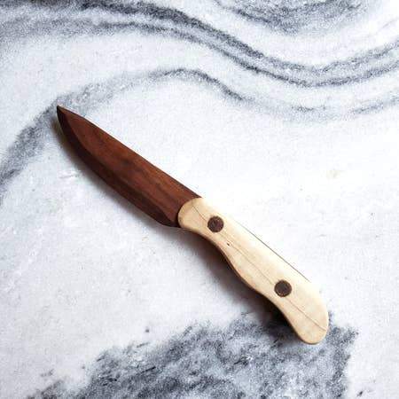 A beautifully crafted paring knife featuring a walnut blade and a maple handle, ideal for cutting herbs, fruits, and vegetables.