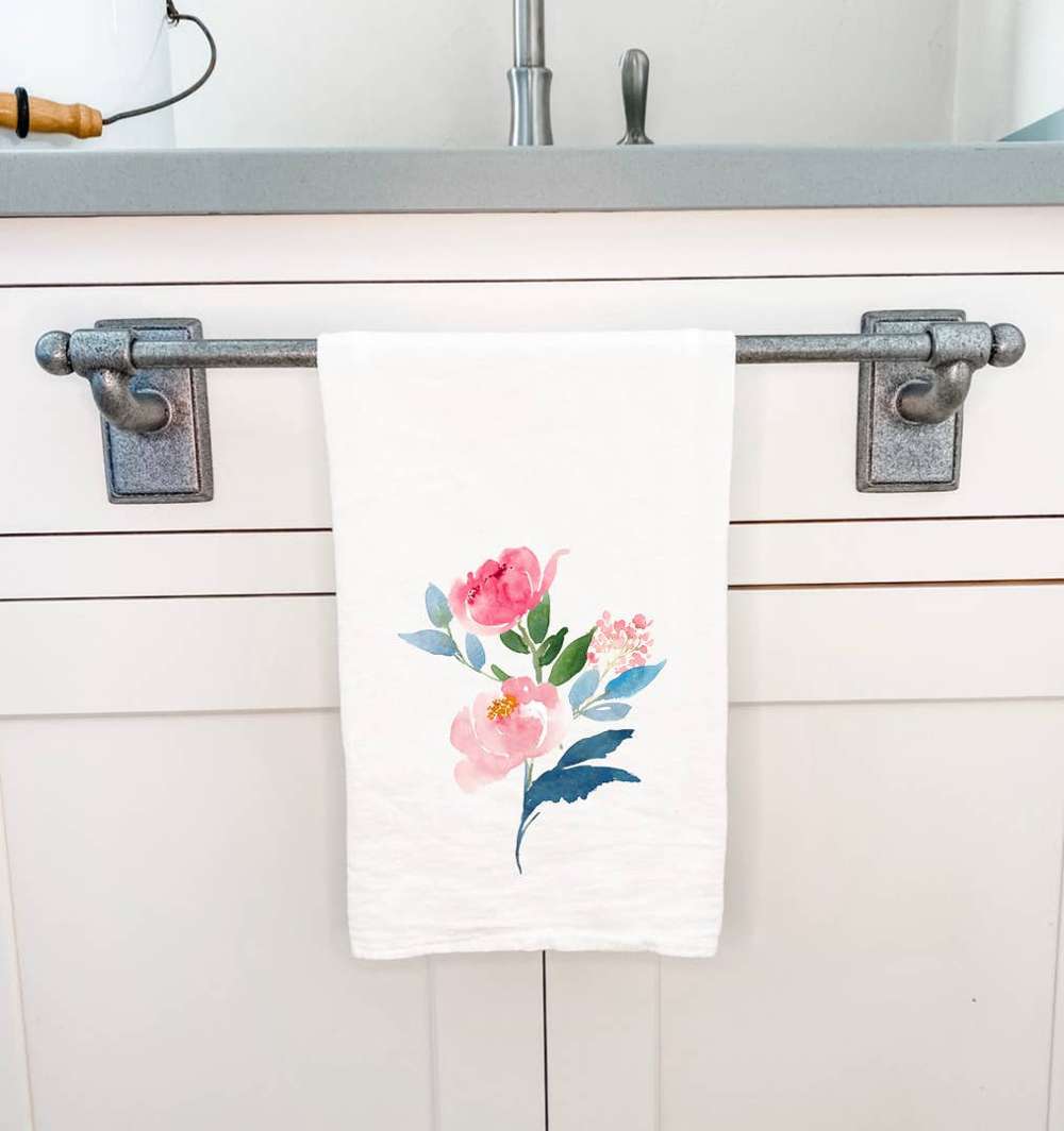 A vibrant cotton tea towel featuring a beautiful peony stems design, perfect for kitchen use.