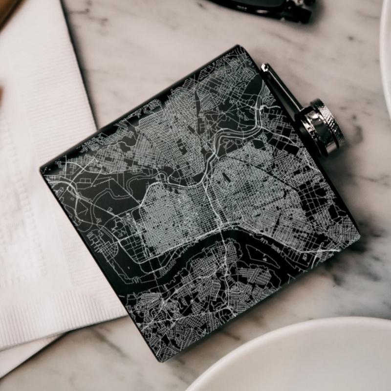 Custom engraved matte black hip flask featuring a Philadelphia map and coordinates, with a canvas bag and funnel included.