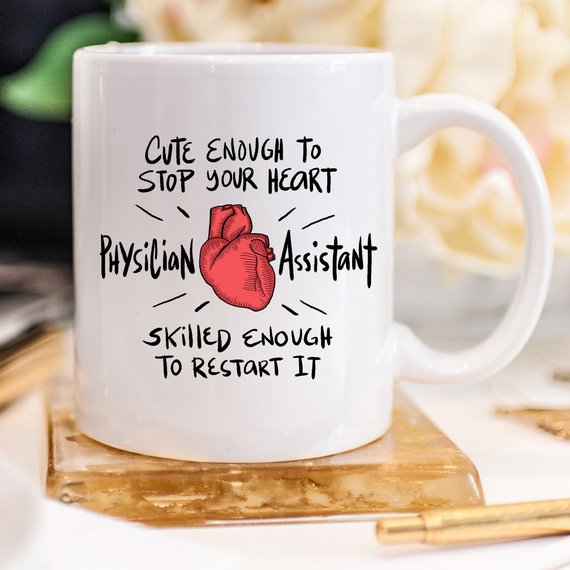 A humorous coffee mug designed for Physician Assistants, featuring the phrase 'Cute Enough To Stop Your Heart' in a vibrant print on a white ceramic background.