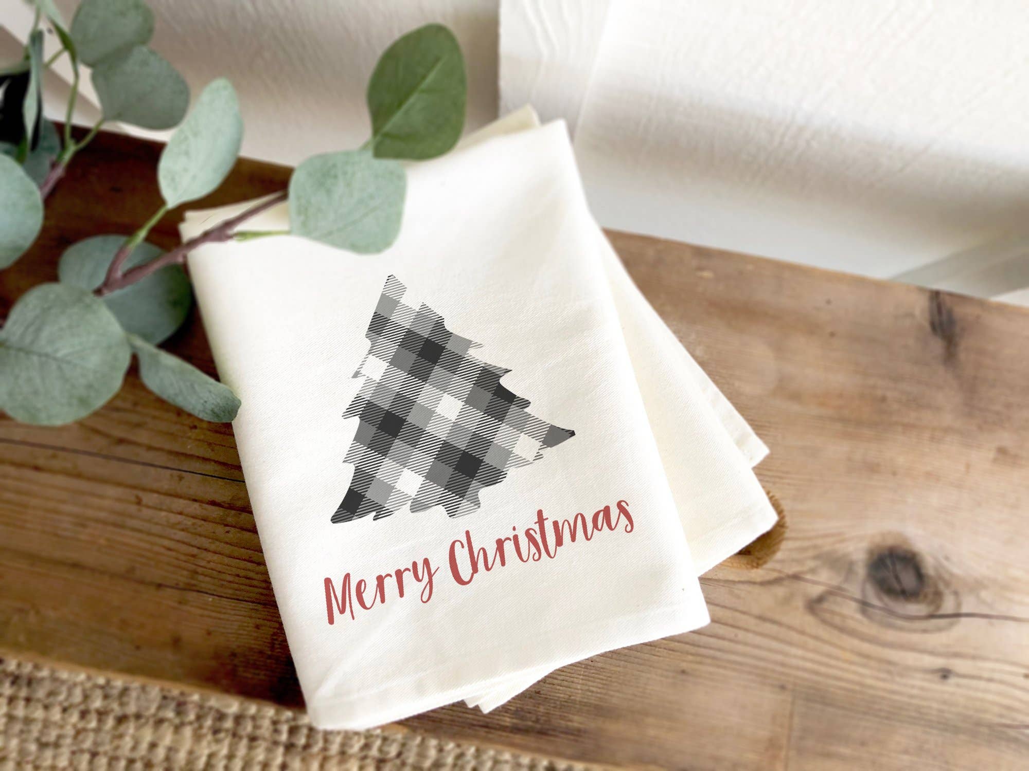 Plaid Christmas Tree cotton tea towel featuring vibrant colors and hemmed edges, perfect for holiday kitchen decor.