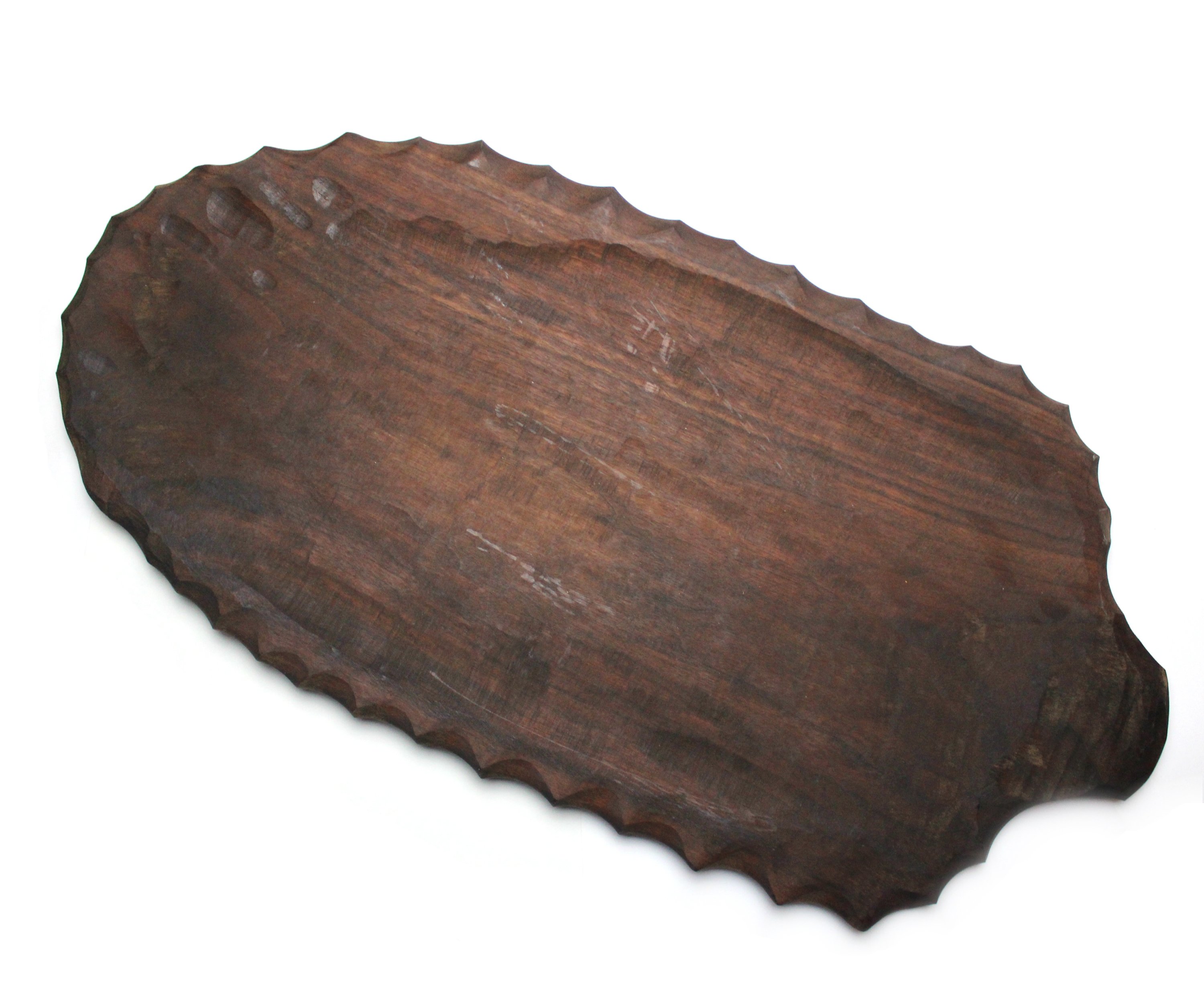 Handcarved wooden platter with leaf shape handle and chiseled edge, perfect for serving turkey, meat, and cheese.