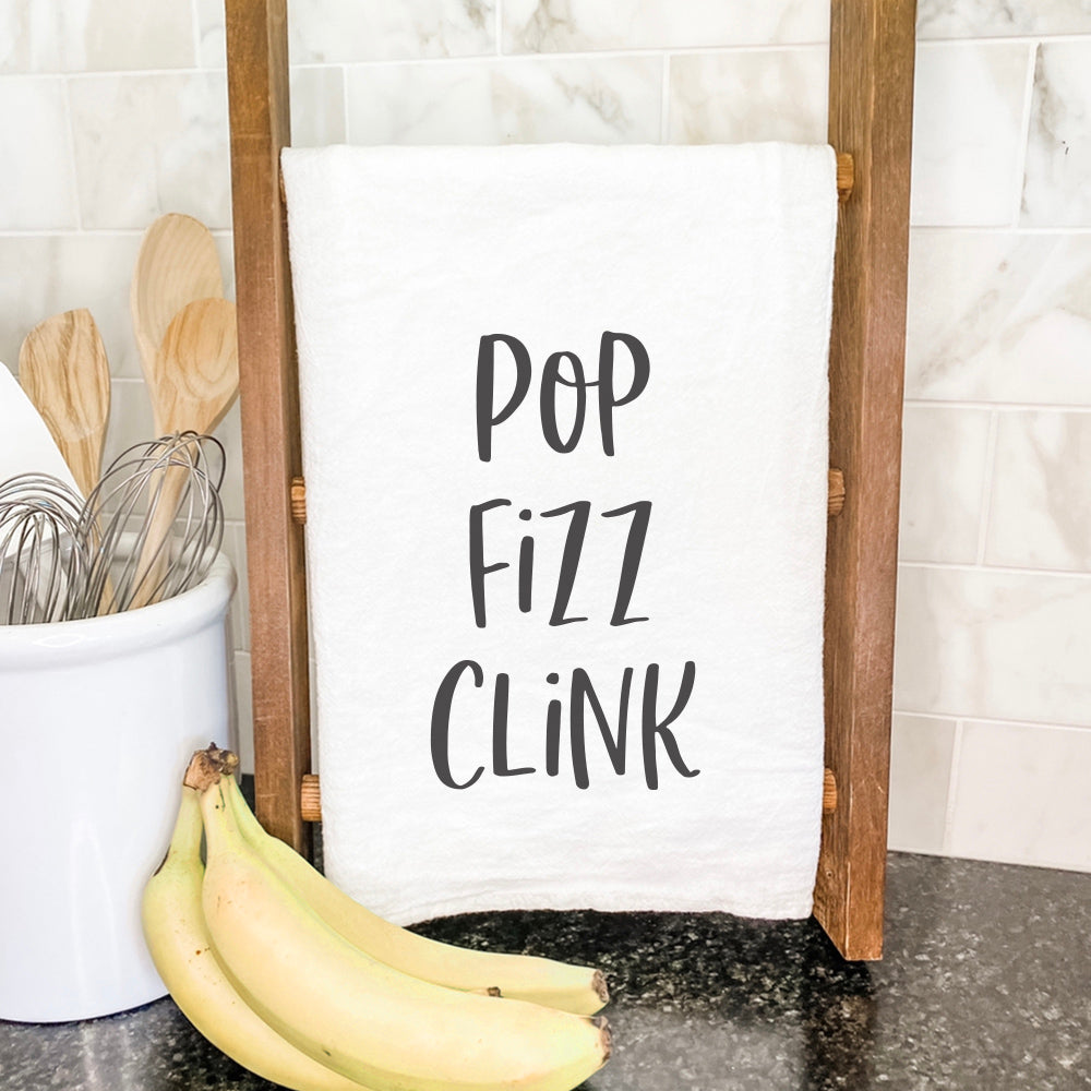 Pop Fizz Clink cotton tea towel featuring vibrant design and hemmed edges, perfect for kitchen use.