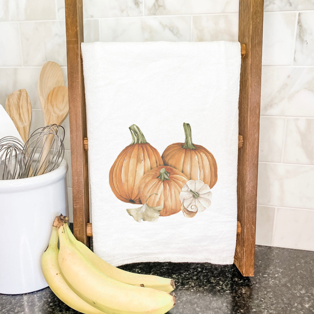 Pumpkin Harvest Cotton Tea Towel featuring vibrant pumpkin design, hemmed edges, and 100% absorbent cotton material.