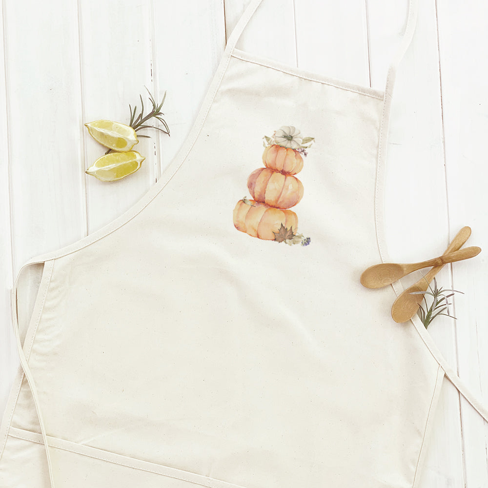 Pumpkin Stack Women's Apron featuring a charming pumpkin design, made from durable cotton canvas with adjustable neck and twill ties.