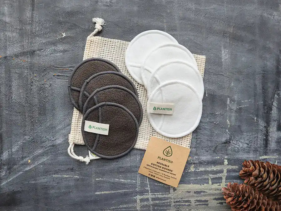 A set of reusable cotton rounds made from cotton and bamboo, displayed in an organic mesh bag, showcasing their eco-friendly design.