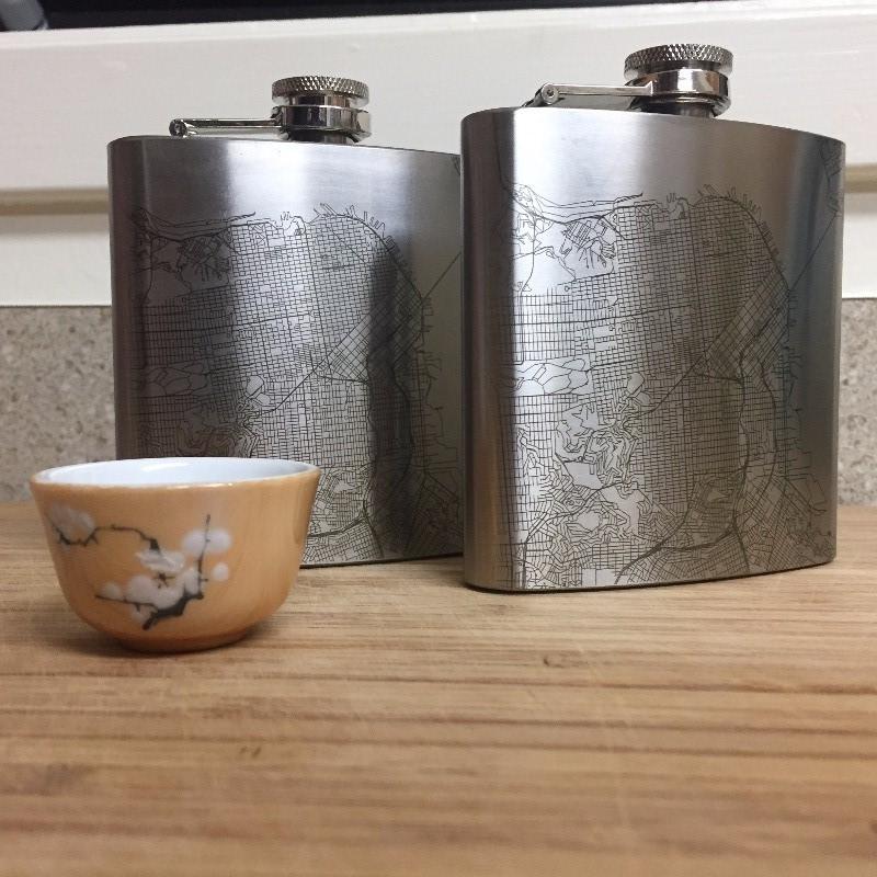 Custom engraved 6oz hip flask featuring a detailed map of Rocky Mountain National Park, Colorado, with a canvas bag and funnel.