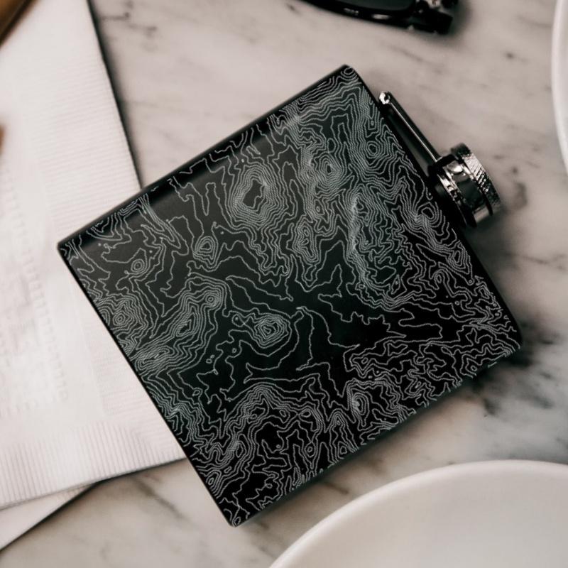 Custom engraved matte black hip flask featuring a detailed map of Rocky Mountain National Park, Colorado, with coordinates.