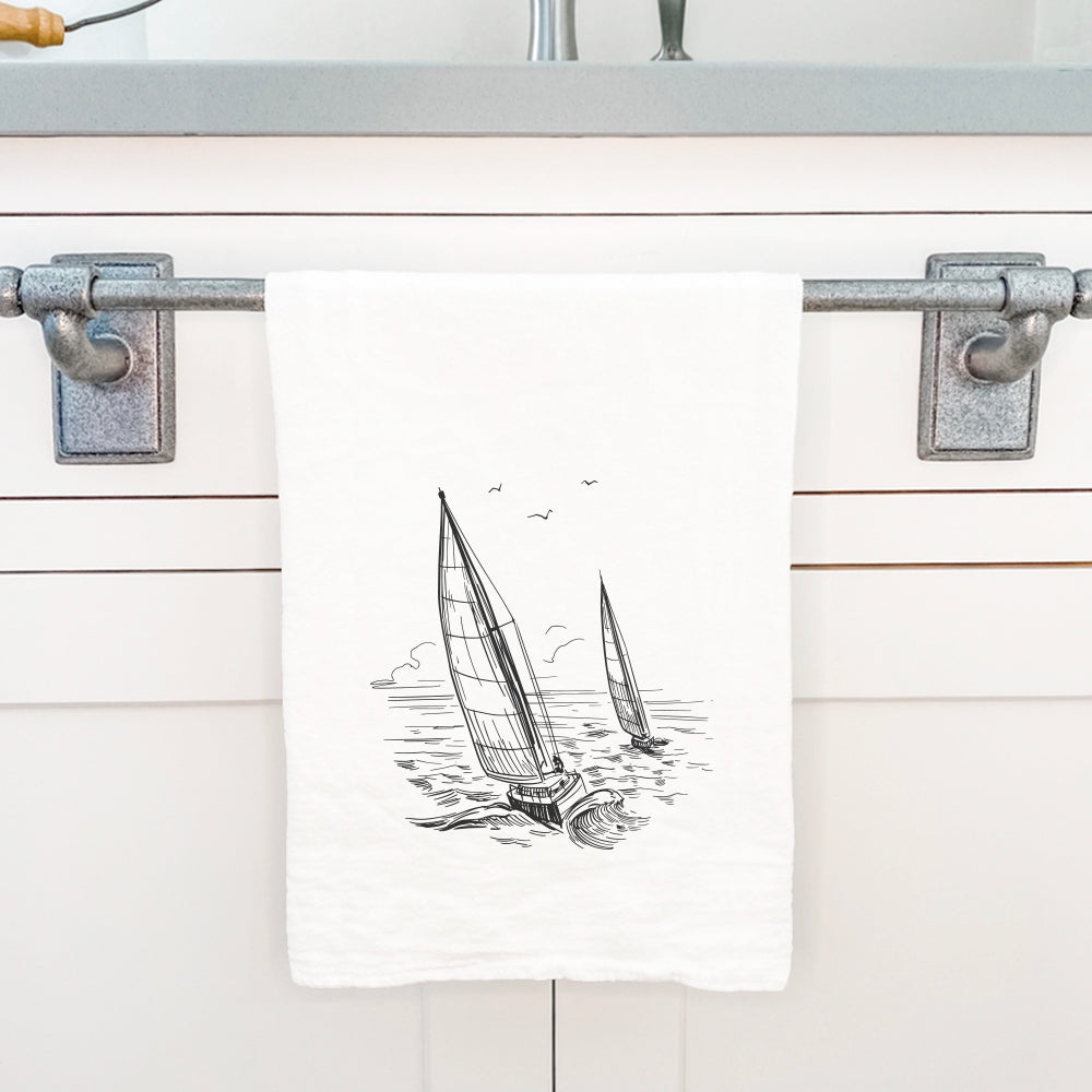 A vibrant cotton tea towel featuring a sailboat design, perfect for kitchen use.