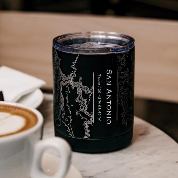 Matte black insulated cup featuring a custom engraved map of San Antonio, Texas with coordinates.