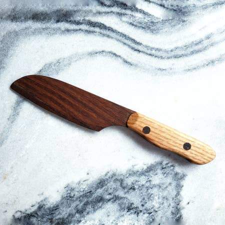 Santoku Wooden Chef Knife with a sleek wooden handle and a sharp blade, ideal for slicing and chopping vegetables.