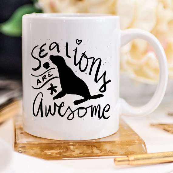 A vibrant coffee mug featuring a playful sea lion design, perfect for coffee lovers and animal enthusiasts.