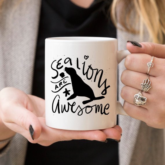 A vibrant coffee mug featuring a playful sea lion design, perfect for coffee lovers and animal enthusiasts.