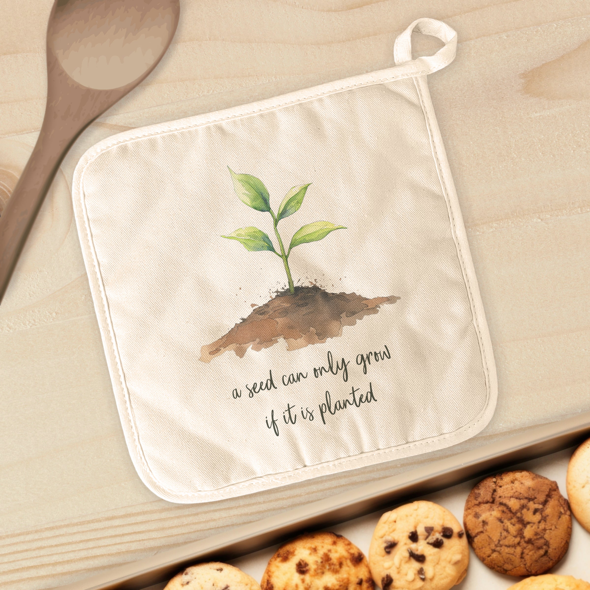 Seedling Quote Cotton Pot Holder featuring vibrant designs and a convenient hanging loop, perfect for kitchen use.