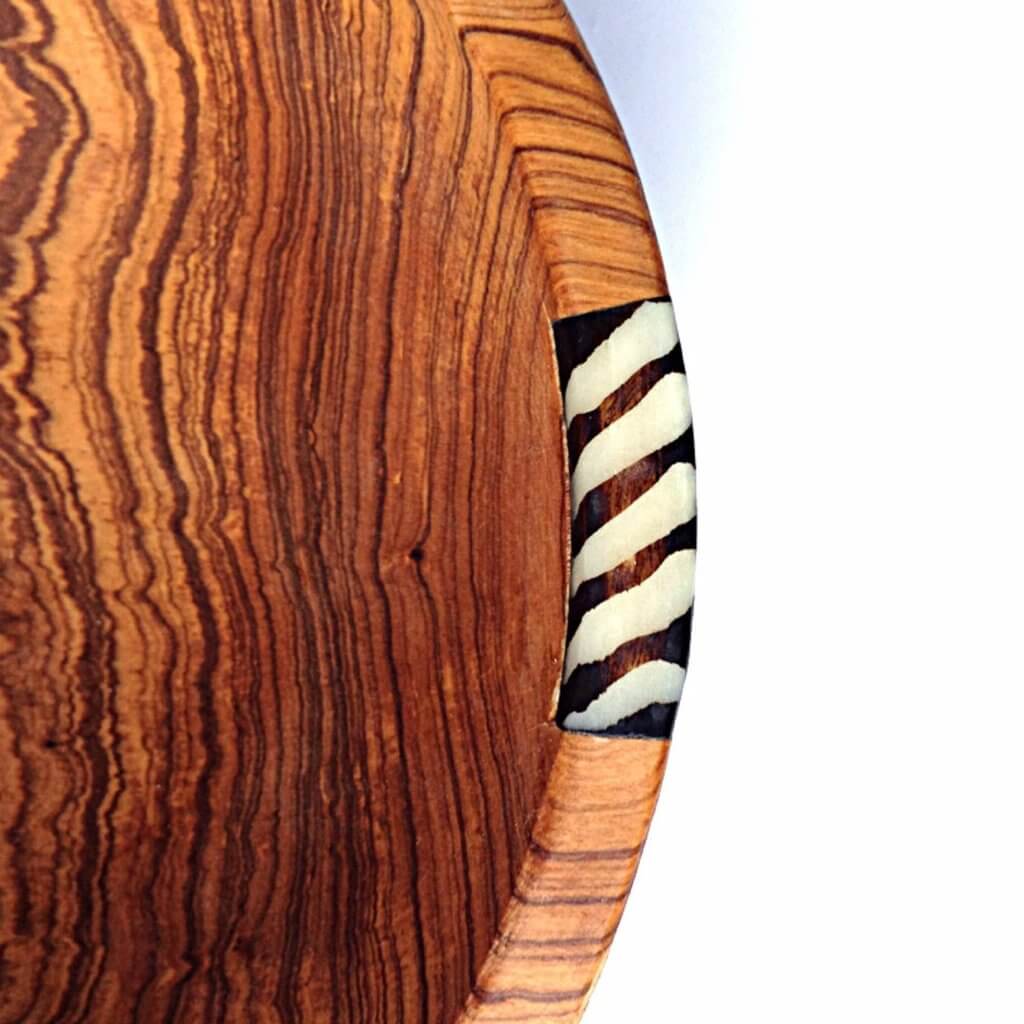 A beautifully handcrafted set of three African olive wood salad and fruit bowls, showcasing unique grain patterns and batik cow bone decoration.