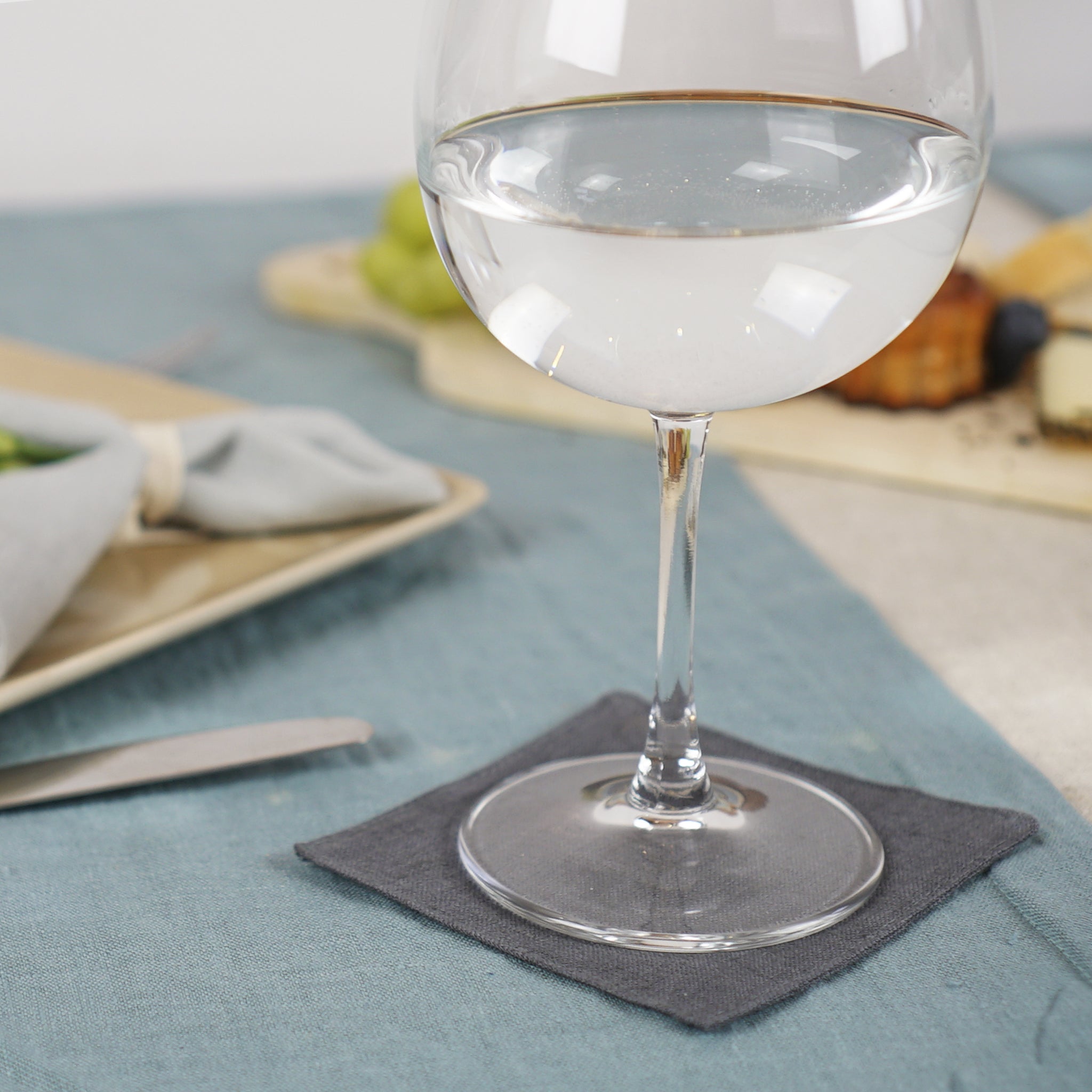 Set of two natural linen coasters in various colors, perfect for protecting tables from hot and cold beverages.