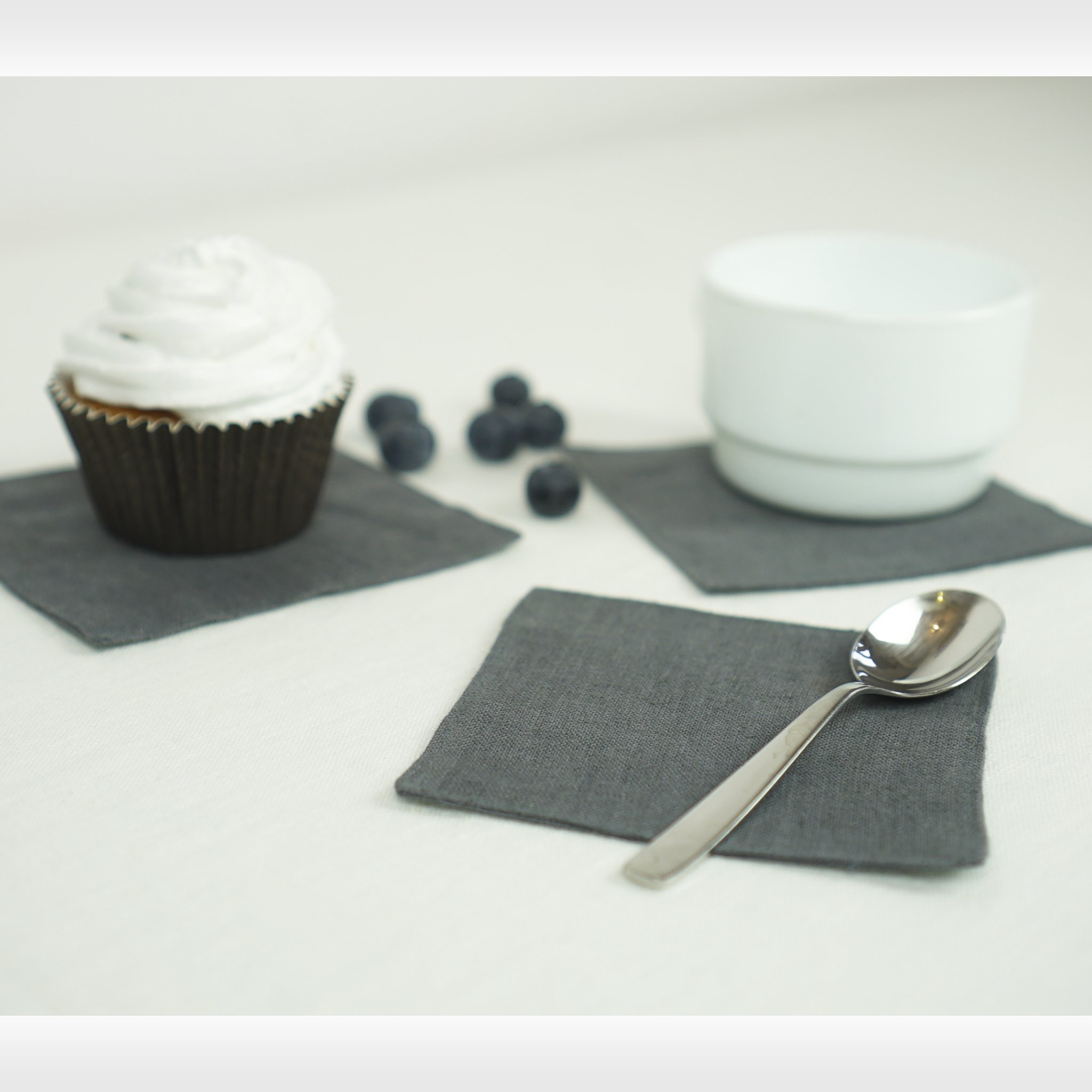 Set of two natural linen coasters in various colors, perfect for protecting tables from hot and cold beverages.