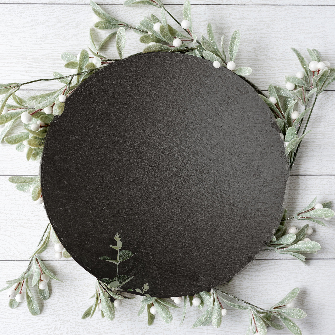 11-inch round slate cheese board with natural edges, perfect for serving appetizers and cheeses.