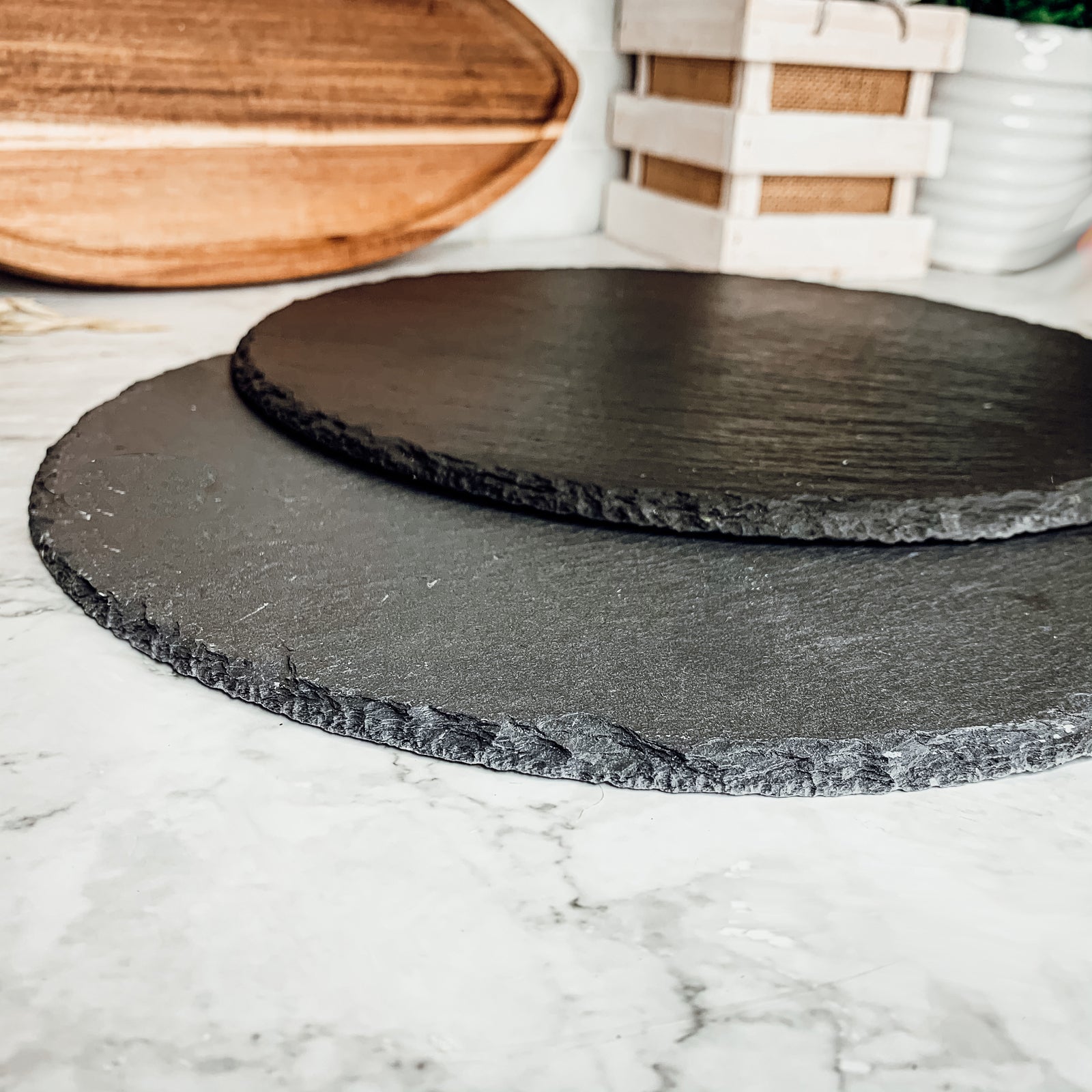 11-inch round slate cheese board with natural edges, perfect for serving appetizers and cheeses.