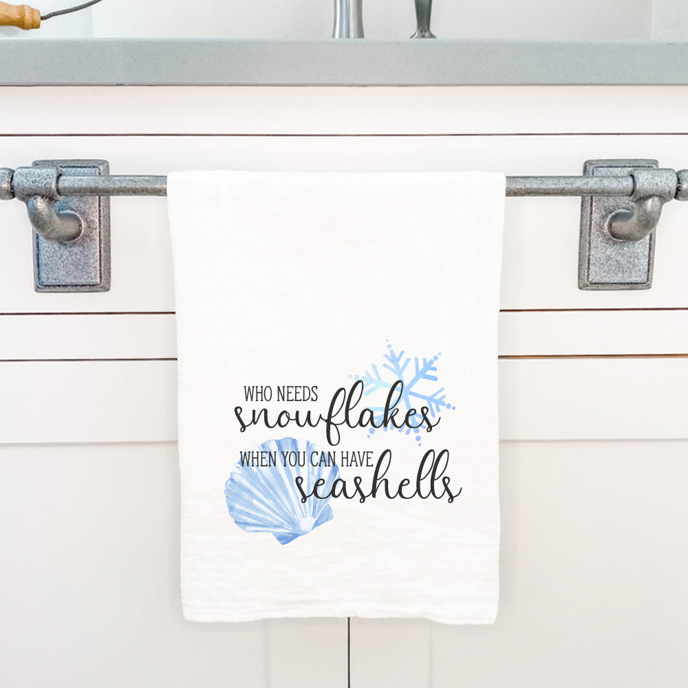 A vibrant cotton tea towel featuring a unique Snowflakes and Seashells design, perfect for kitchen use.