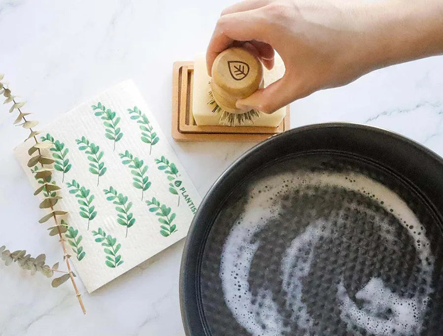 Eco-friendly Solid Dish Soap Bar displayed on a bamboo soap dish, showcasing its natural ingredients and sustainable packaging.