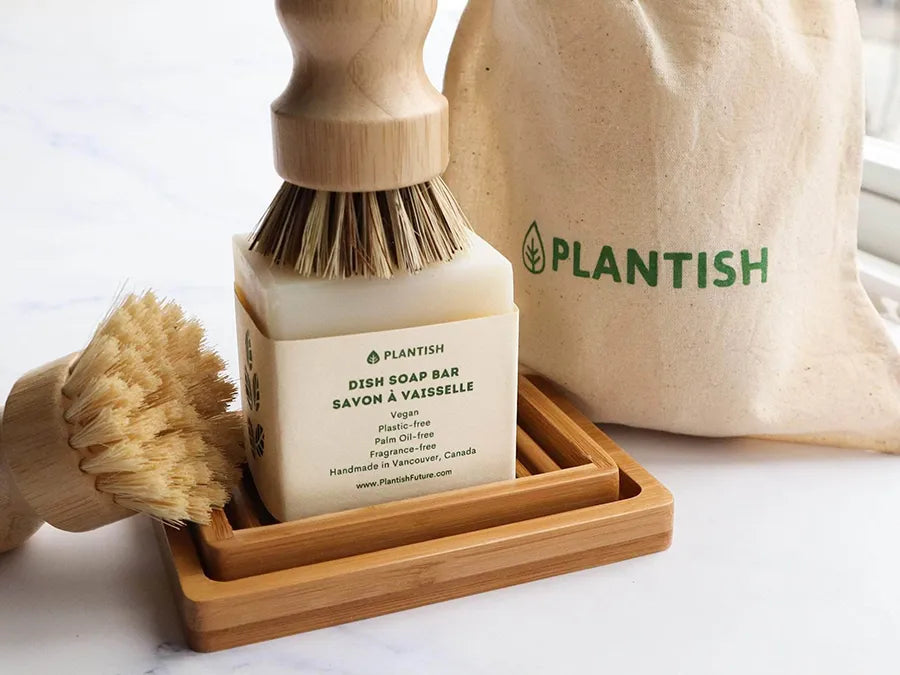 Eco-friendly Solid Dish Soap Bar displayed on a bamboo soap dish, showcasing its natural ingredients and sustainable packaging.