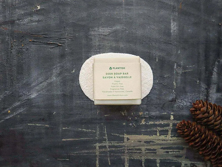 Eco-friendly Solid Dish Soap Bar displayed on a bamboo soap dish, showcasing its natural ingredients and sustainable packaging.