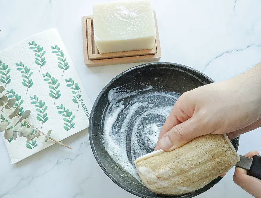 Solid Dish Soap Brick (13oz) displayed on a bamboo soap dish, showcasing its eco-friendly packaging and natural ingredients.