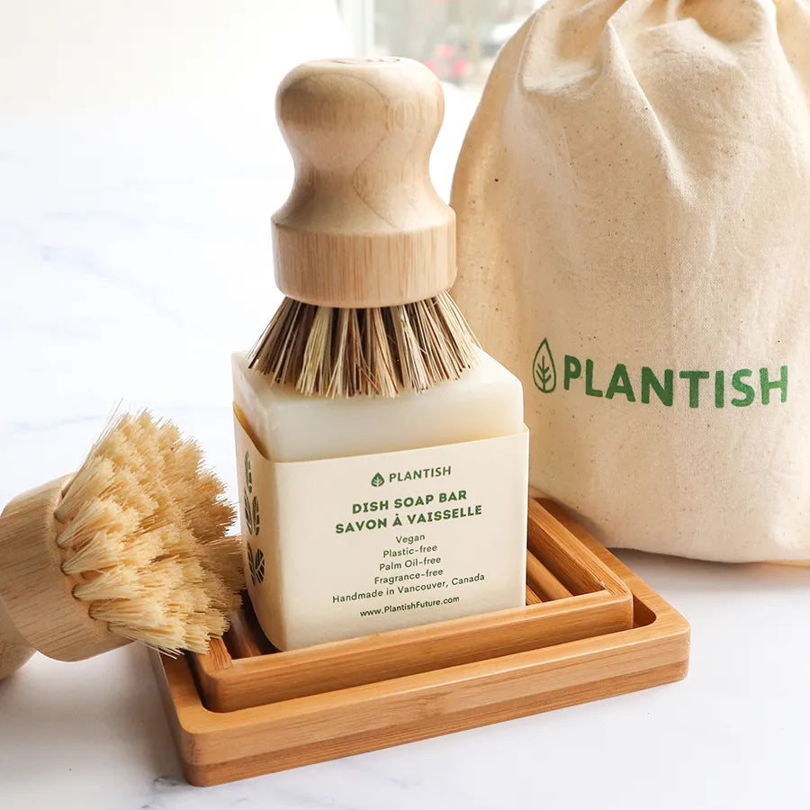 Solid Dish Soap Brick (13oz) displayed on a bamboo soap dish, showcasing its eco-friendly packaging and natural ingredients.