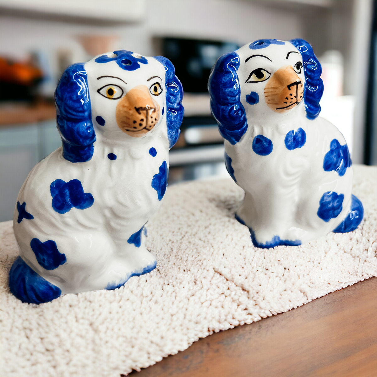 Hand-painted Staffordshire dog salt and pepper shakers in blue and white ceramic, showcasing intricate details and a high glaze finish.