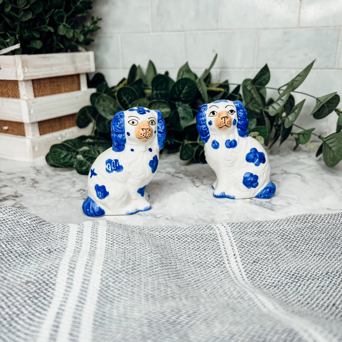 Hand-painted Staffordshire dog salt and pepper shakers in blue and white ceramic, showcasing intricate details and a high glaze finish.