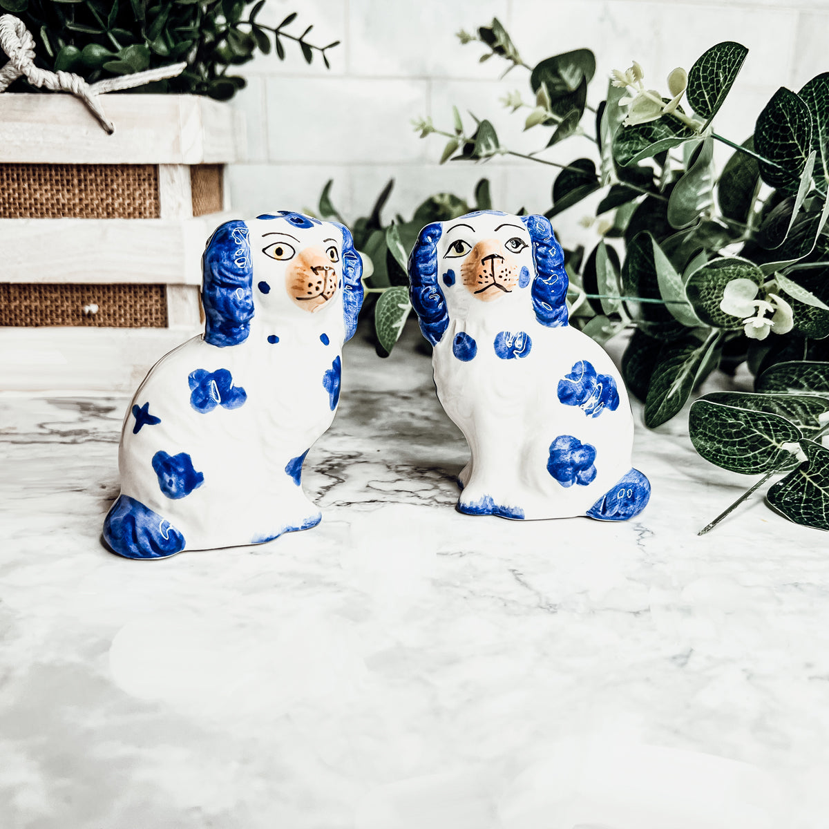 Hand-painted Staffordshire dog salt and pepper shakers in blue and white ceramic, showcasing intricate details and a high glaze finish.