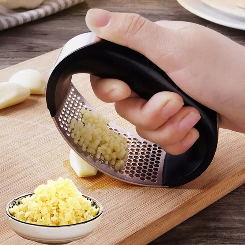 A sleek stainless steel garlic press with an ergonomic rocking design, ideal for crushing garlic effortlessly.