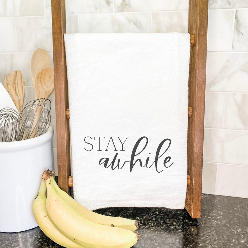 Stay Awhile Cotton Tea Towel featuring vibrant design and hemmed edges, perfect for kitchen use.