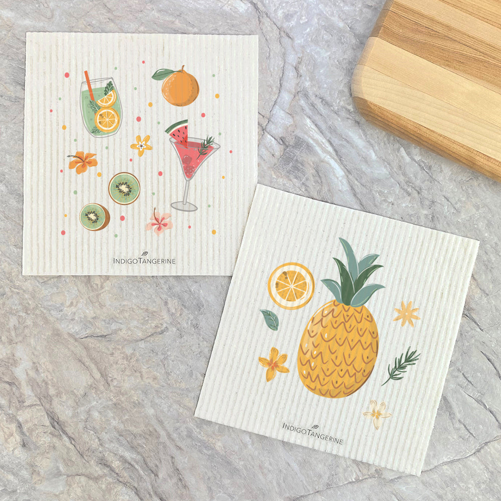 Two eco-friendly Swedish dishcloths featuring a vibrant pineapple design, made from plant-based fibers.