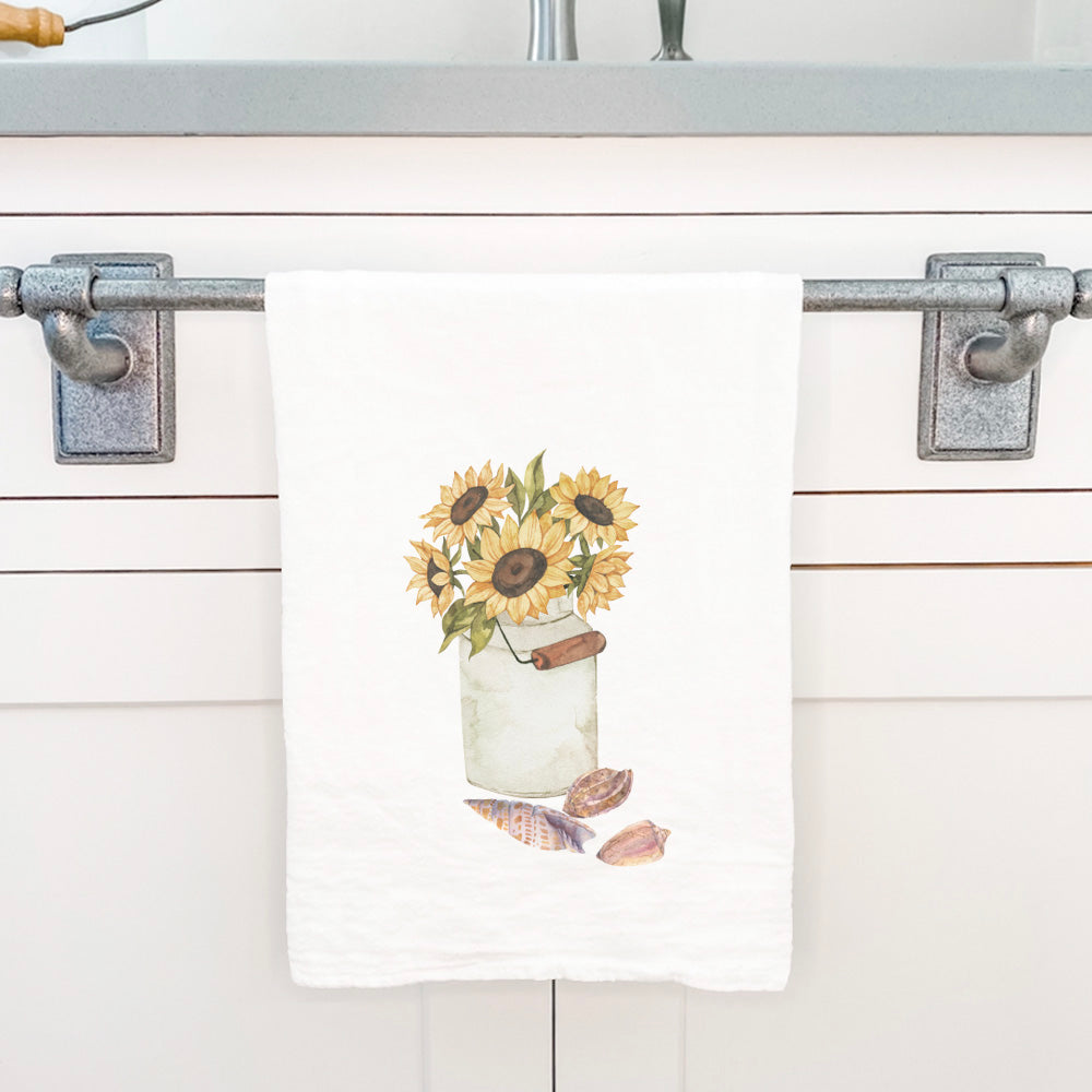 A vibrant cotton tea towel featuring sunflowers and seashells design, perfect for kitchen use.