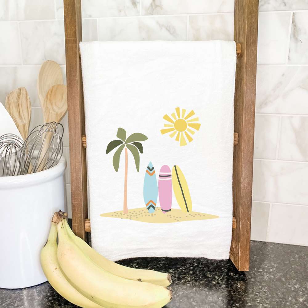 A vibrant cotton tea towel featuring a surfboard design, perfect for kitchen use.