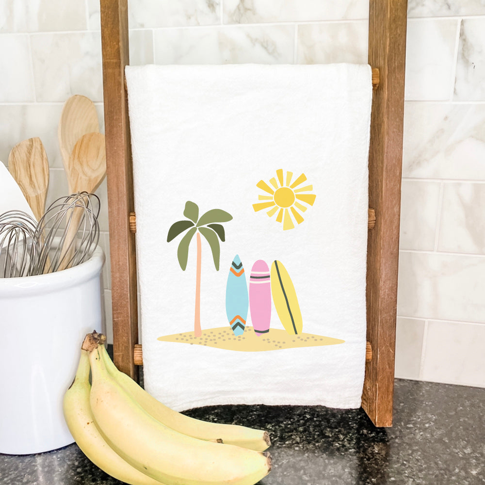 A vibrant cotton tea towel featuring a surfboard design, perfect for kitchen use.