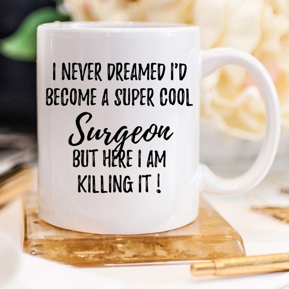 A white ceramic mug designed for surgeons, featuring a vibrant print on both sides, showcasing a thoughtful gift for medical professionals.