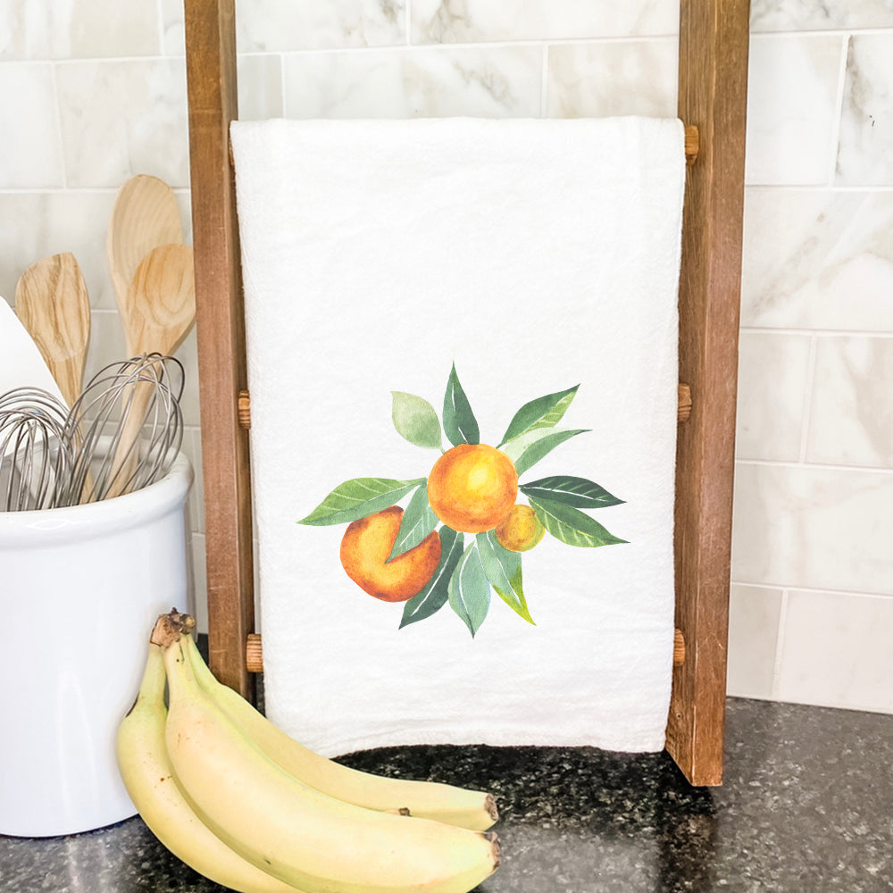 Tangerine Bunch cotton tea towel featuring vibrant orange and green designs on a white background, perfect for kitchen use.