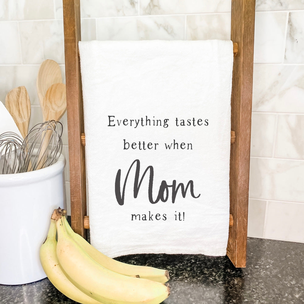 Tastes Better Mom Cotton Tea Towel featuring vibrant design and hemmed edges, perfect for kitchen use.