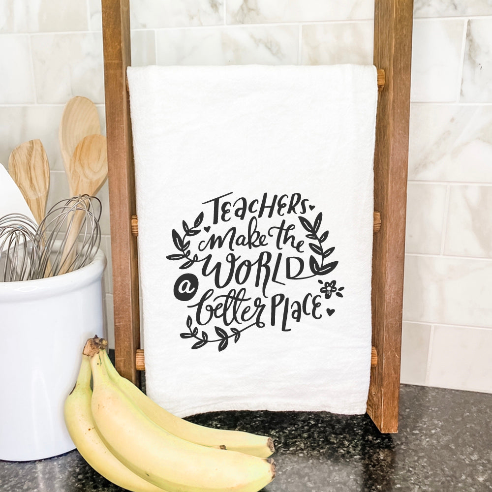 A vibrant cotton tea towel featuring the phrase 'Teachers Make World Better', showcasing a beautiful design printed with water-based inks.