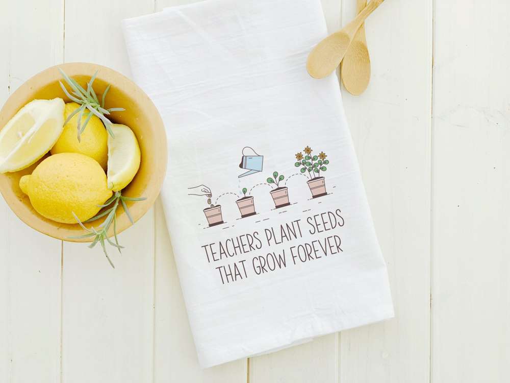 Teachers Plant Seeds That Grow Forever cotton tea towel featuring vibrant design, hemmed edges, and absorbent fabric.