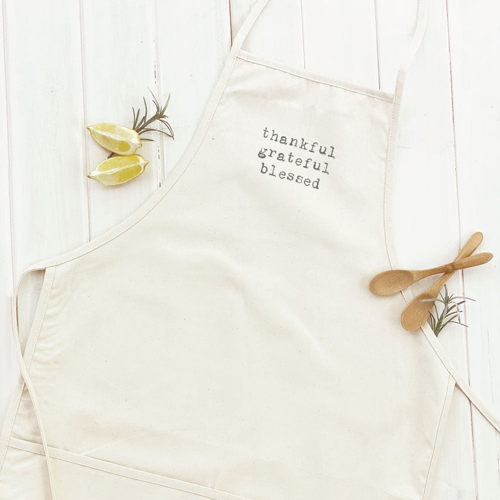 Thankful Grateful Blessed Women's Apron featuring a stylish design, adjustable neck, and divided front pocket, made from durable cotton canvas.