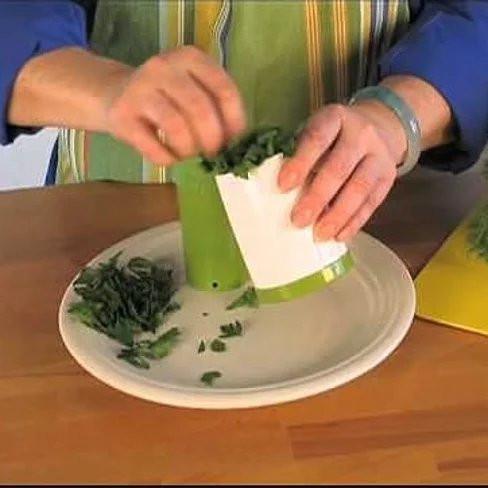 Person chopping herbs on counter