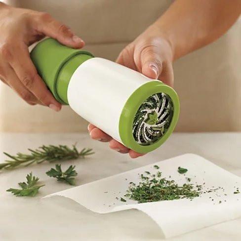 Handheld herb grinder in use.