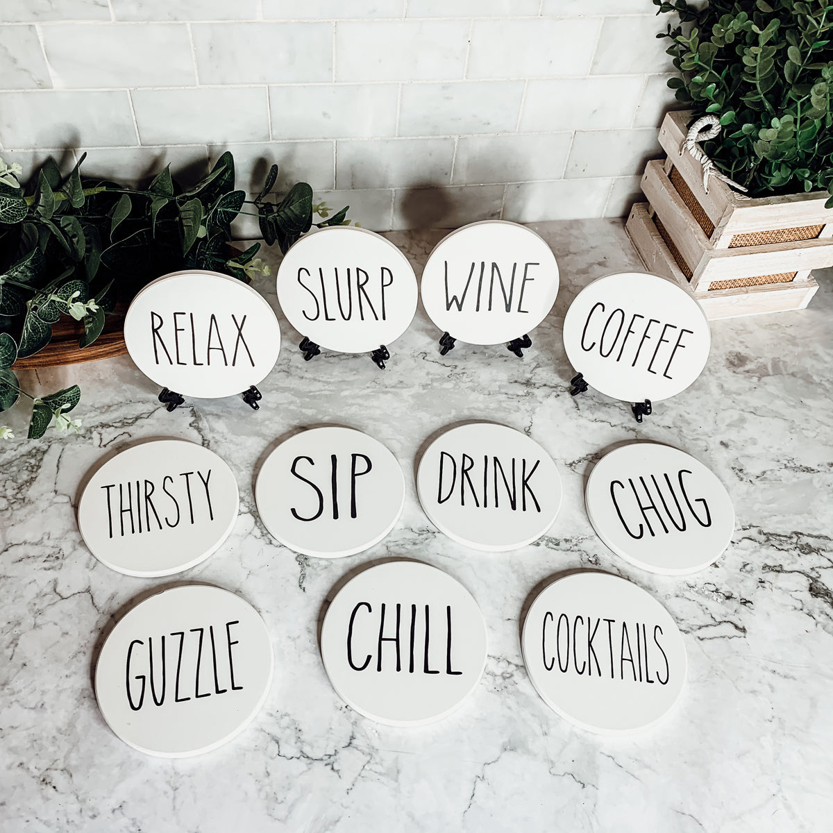 A stylish set of ceramic coasters with cork backing, featuring various fun designs for kitchen decor.