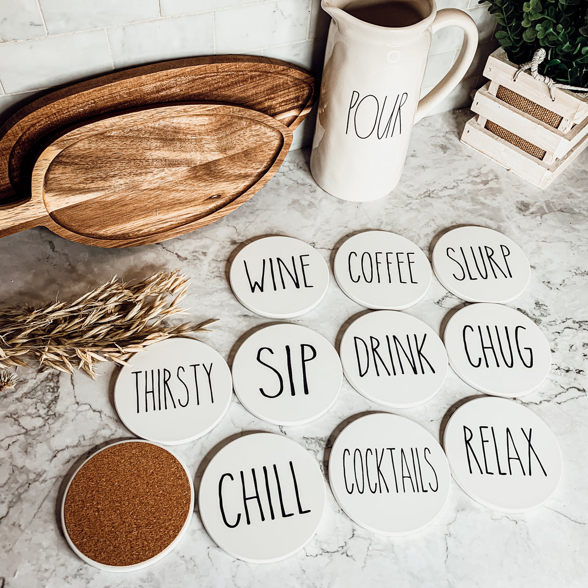 A stylish set of ceramic coasters with cork backing, featuring various fun designs for kitchen decor.